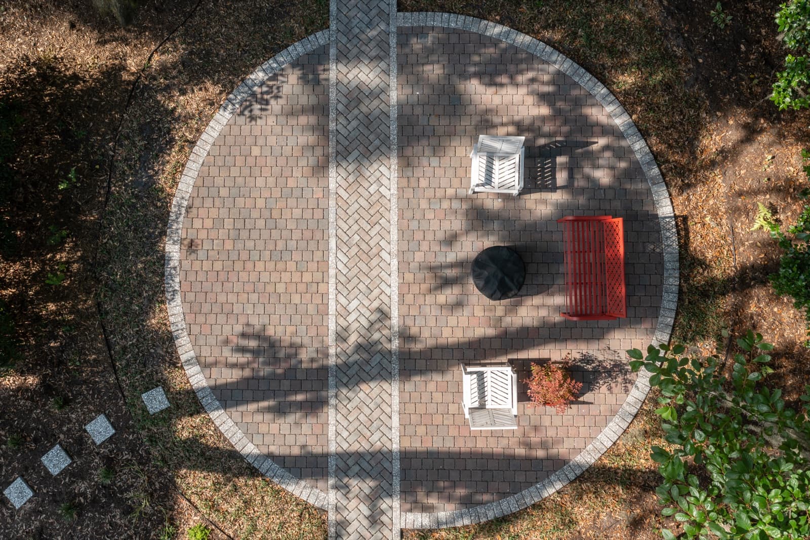 Herringbone paver patio with a contrasting border and a connecting paver path to the home