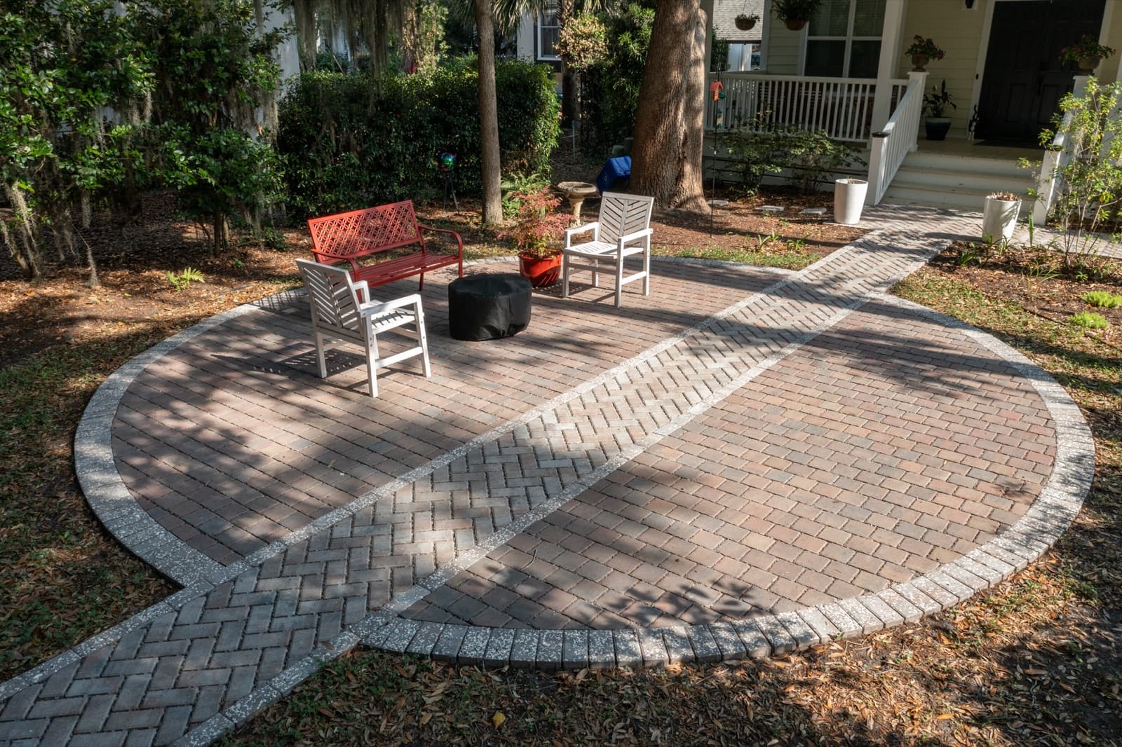 Elevated paver walkway leading from the home to the circular patio