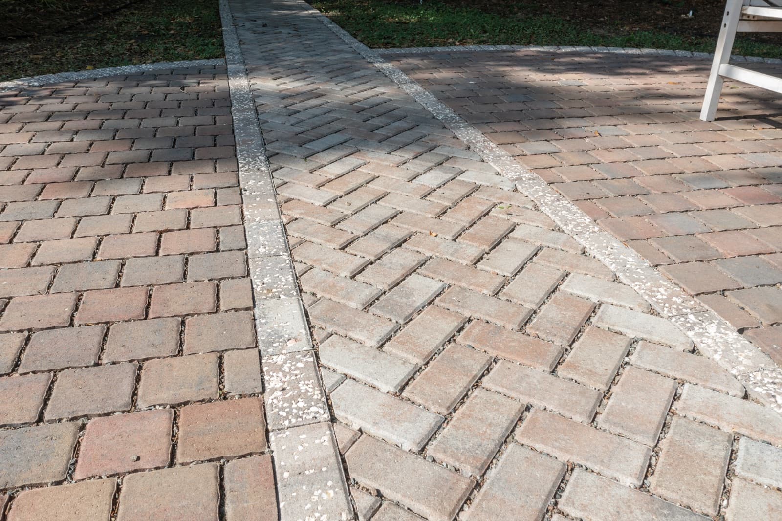 Detail of the herringbone paver field meeting the contrasting soldier-course border