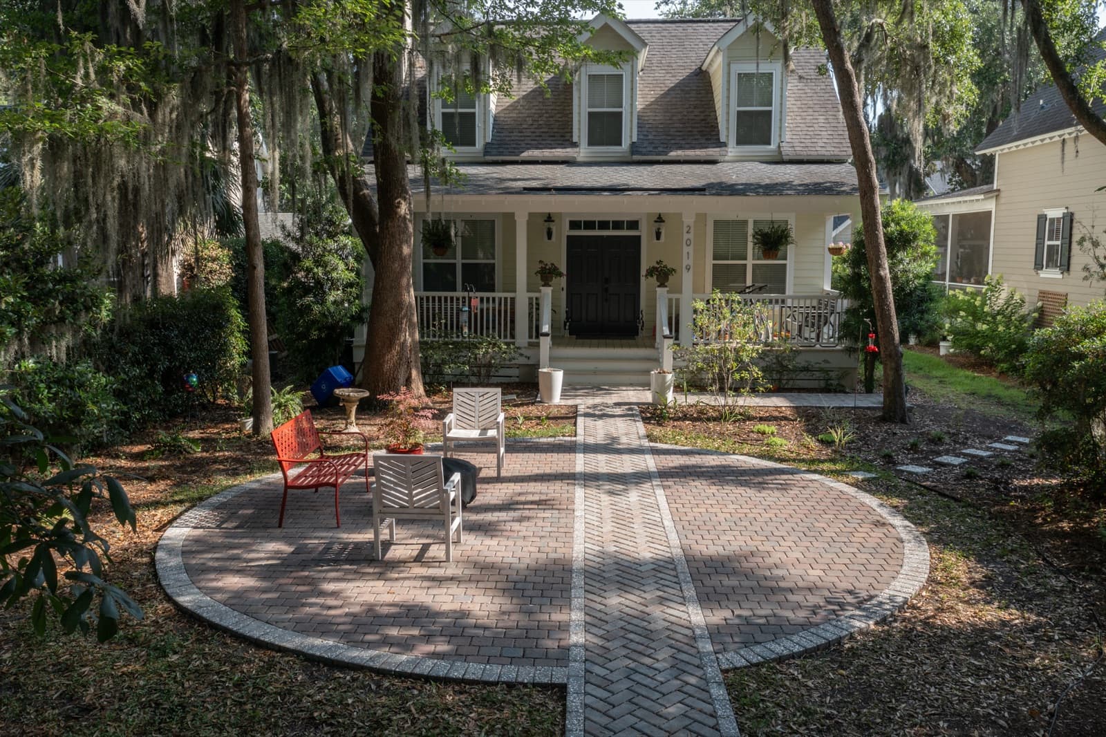 Seating arranged around the fire bowl on the circular paver patio