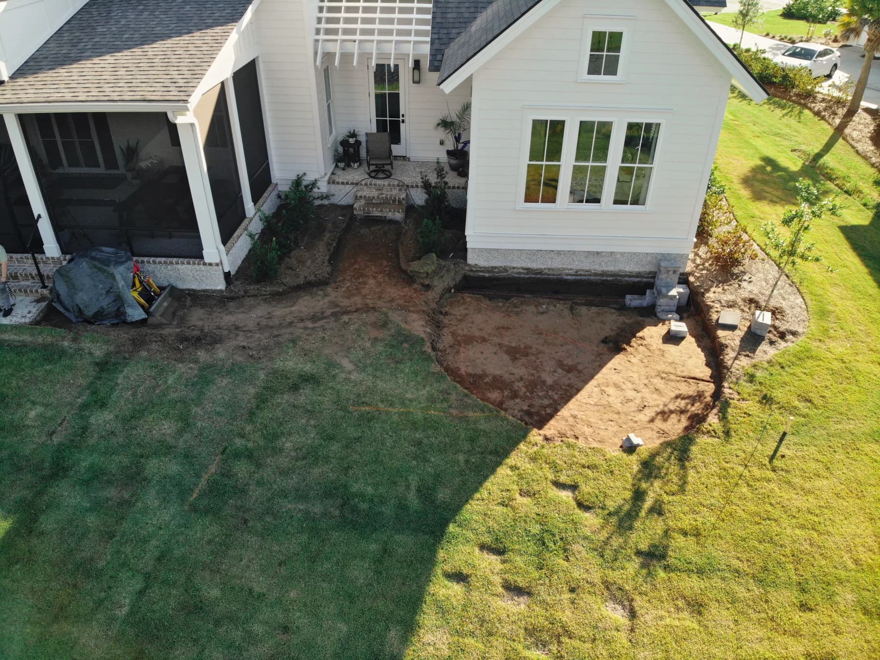 Wide construction view of the compacted base areas for the connected grill patio and sitting-wall patio