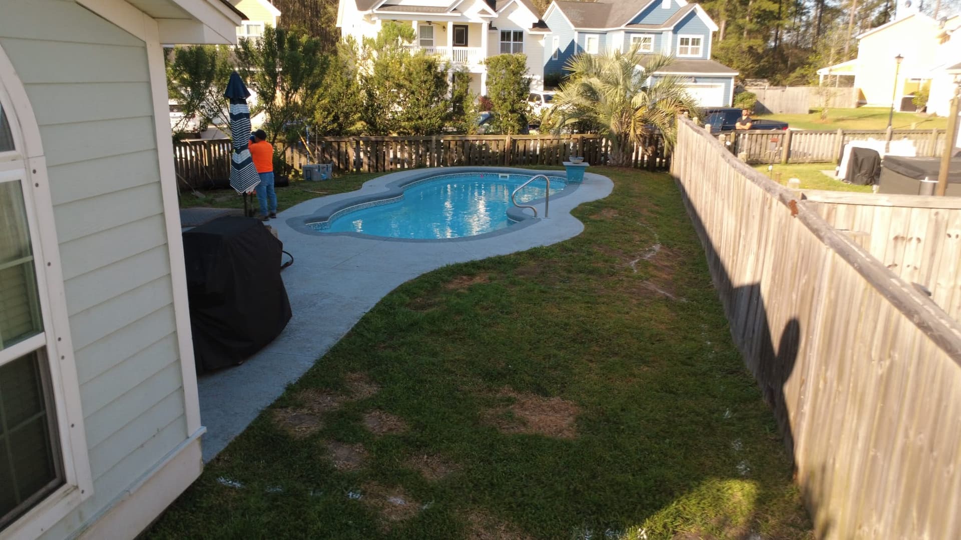 Before: the pool with a narrow concrete surround and worn grass leaving little room for seating in the Mount Pleasant backyard
