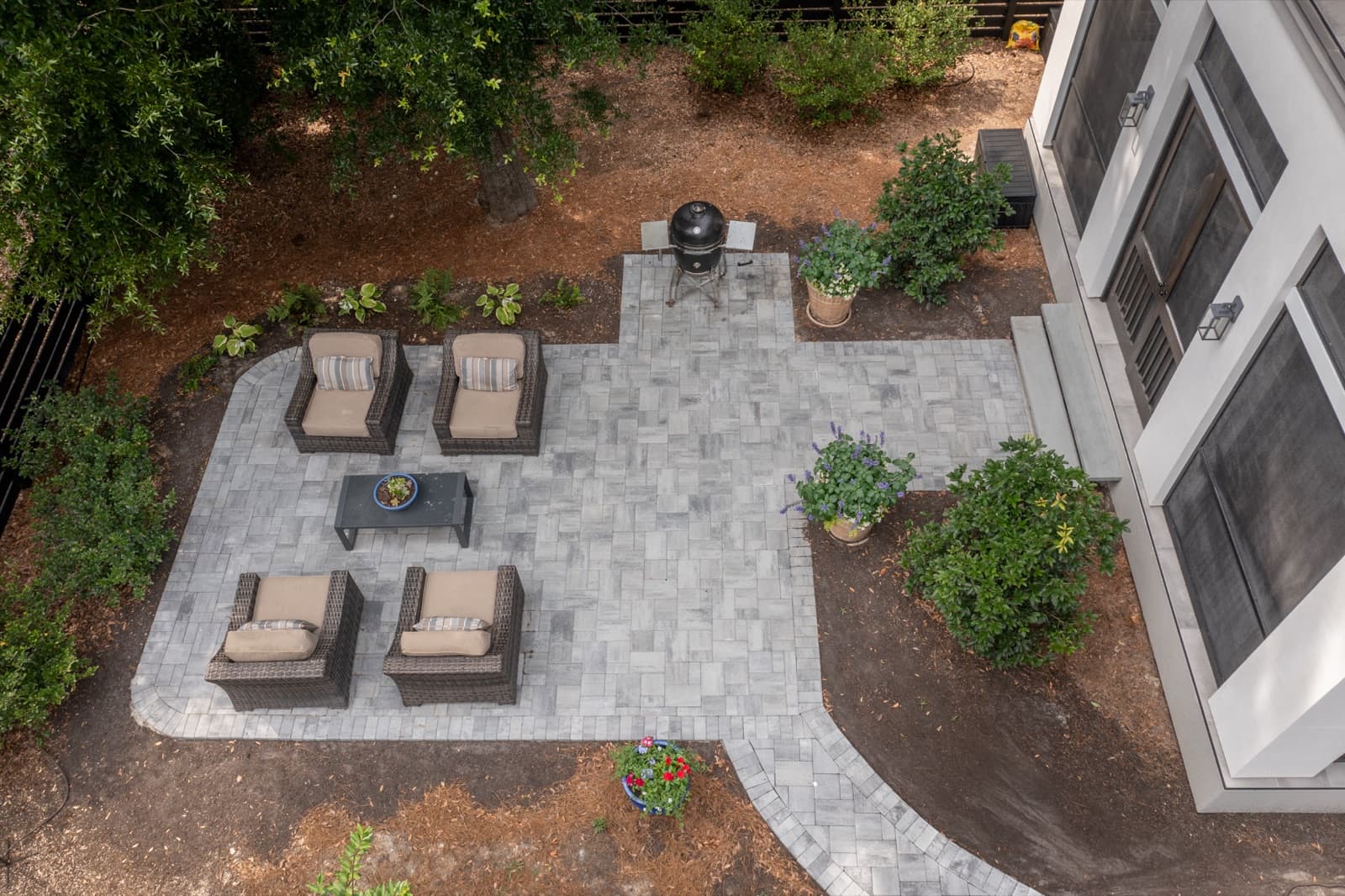 Aerial view of the patio and winding path connecting the front and rear of the home