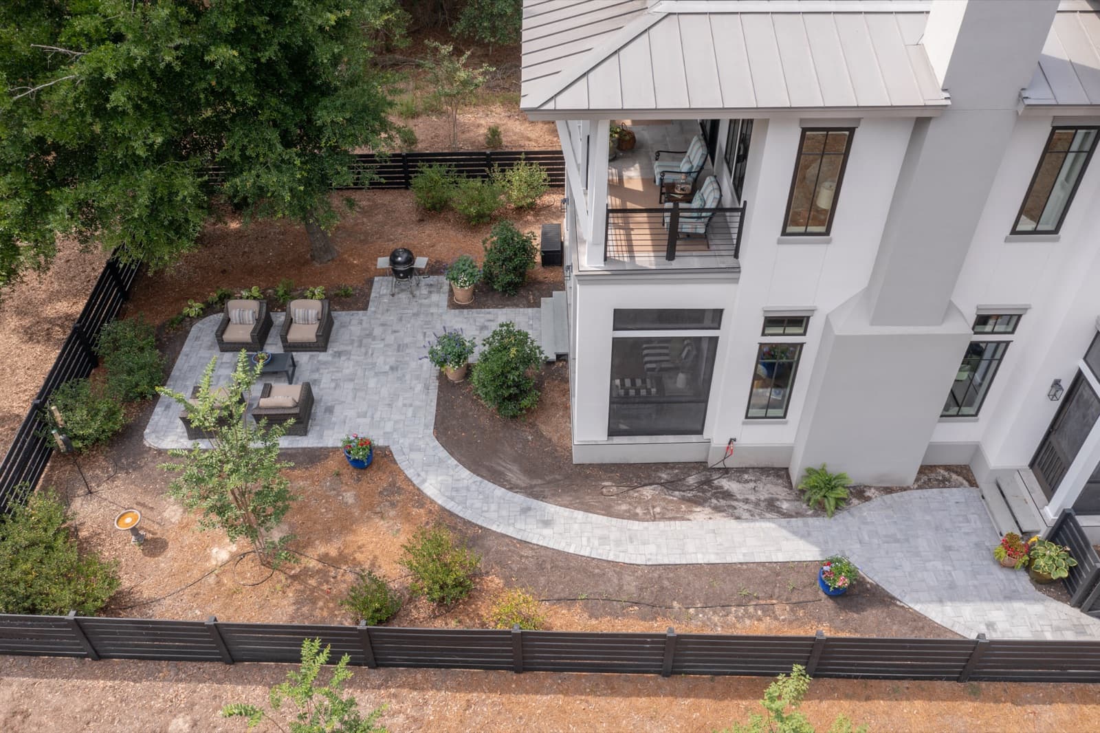 Modern wicker lounge seating arranged on the new paver patio