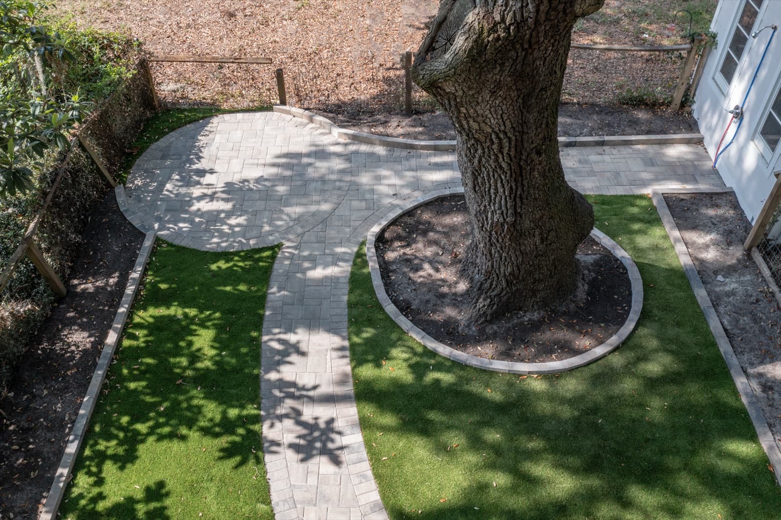 Close view of the circular paver tree-ring protecting the oak root flare