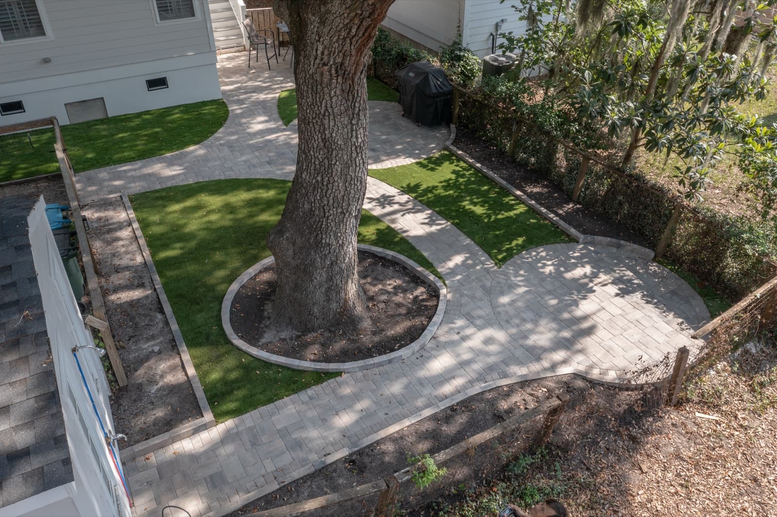 Aerial view of the full turf and paver layout woven around the heritage oak