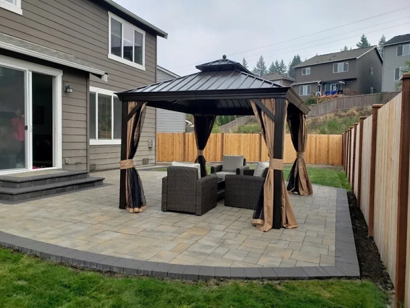 Paver patio shaded by a wooden pergola