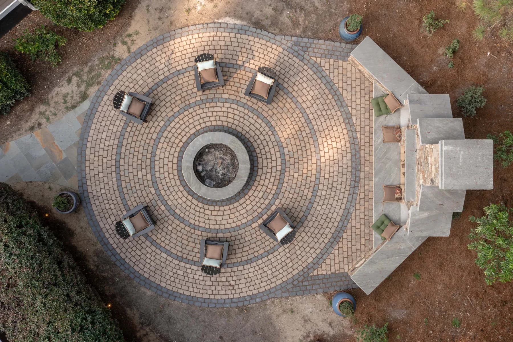 Top-down aerial view of the circular paver patio centered on a round stone fire pit